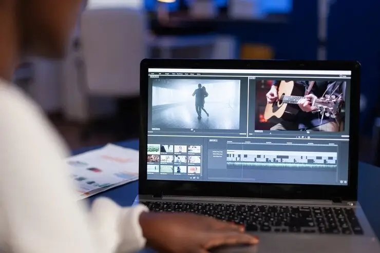 Campus Weekly student editor displaying their video editing software on their laptop screen