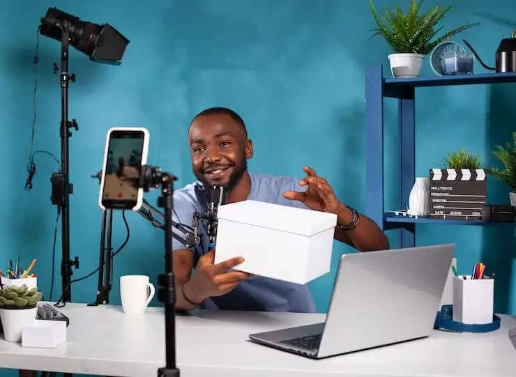 Campus Weekly team member in a studio recording a video show casing a product for an expo