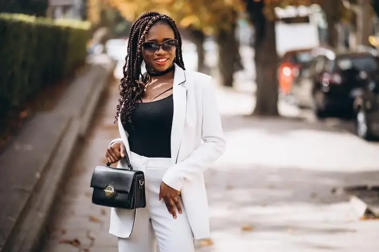 Fashion model woman with a black hand bag