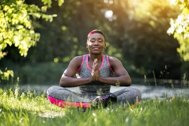 Young lady doing yoga in nature for holistic development